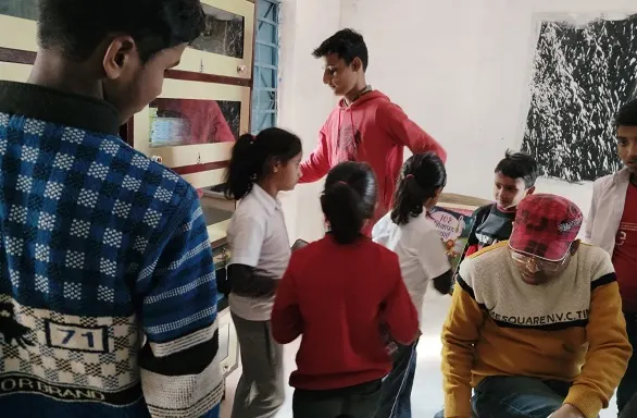 Teacher issuing books inside the library